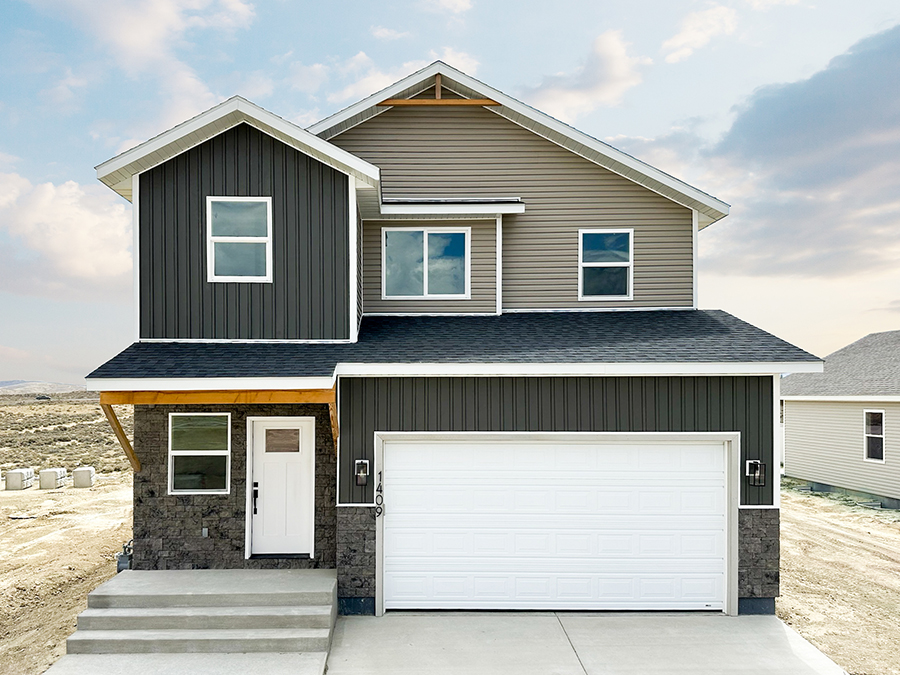  Lindbergh model, depicting a two-story home with a modern exterior, a front porch, a two-car garage, and a well-maintained landscape with grass.